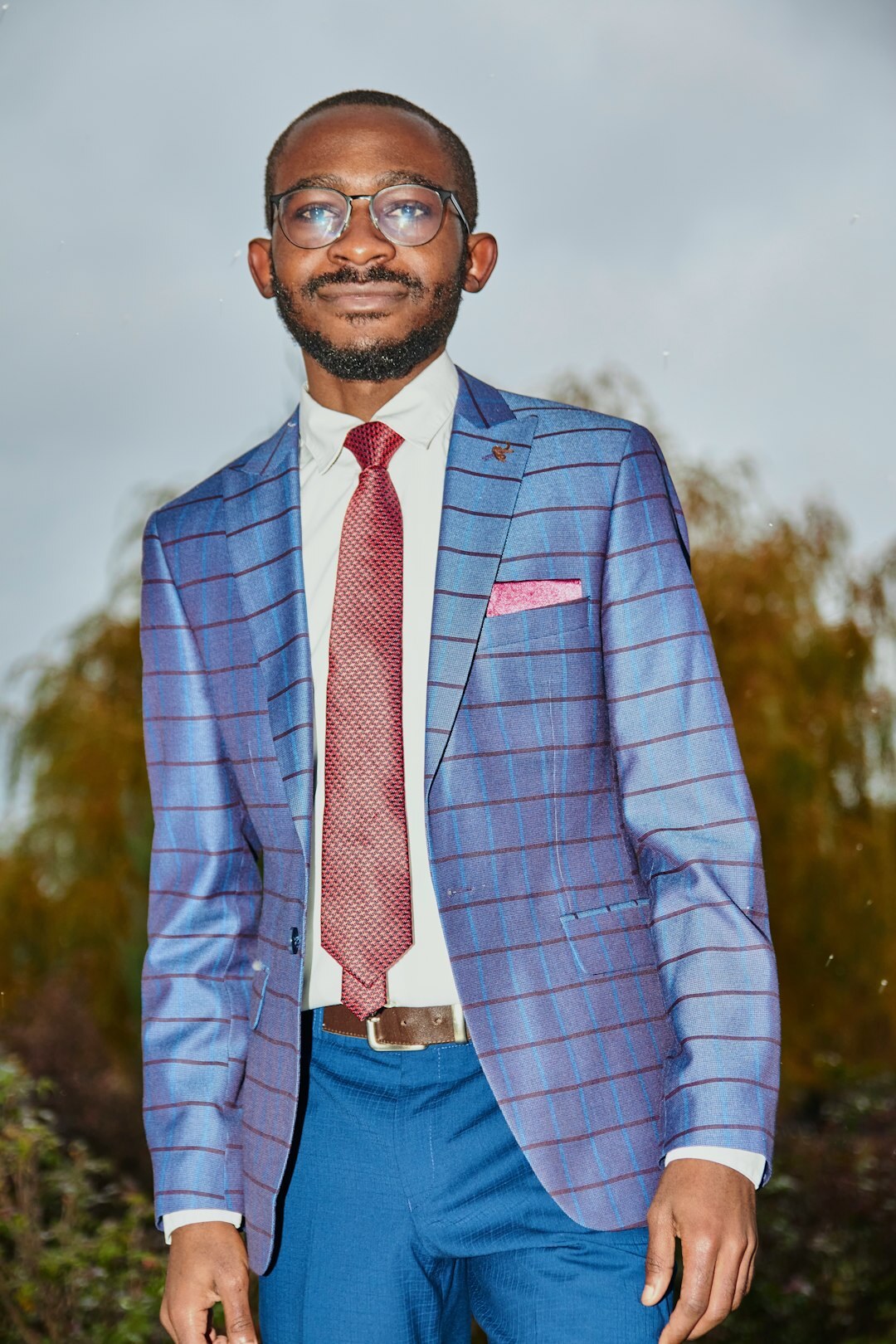 Professional portrait of a man in a blazer smiling